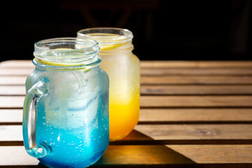 A view of two brightly colored refreshing beverages inside mason jars.