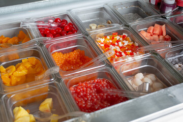 A view of a variety of toppings, seen at a local frozen yogurt restaurant.