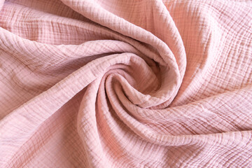 Soft muslin baby blanket background. Cotton clothing and textiles. Natural organic fabrics texture. Light pink rose color. Close up. - obrazy, fototapety, plakaty