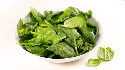 plate of fresh spinach on white background