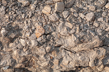 The texture of old stones of various shapes. Close-up of worn masonry.