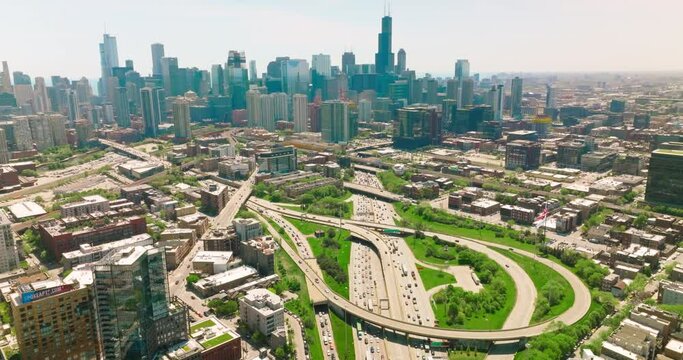 Beautiful sight of a big busy city in America. Multiple-lane roads crossing Chicago city. Sunny day picture of a city from top.