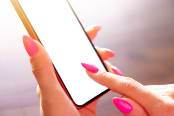 Closeup photo of woman using mobile phone with finger touching the screen