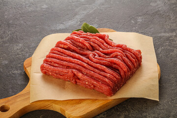 Raw beef minced meat over board