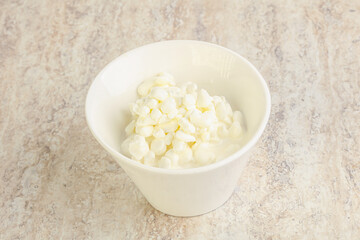 Grained cottage cheese in the bowl