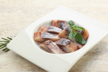Delicous sliced herring fillet in grape sauce