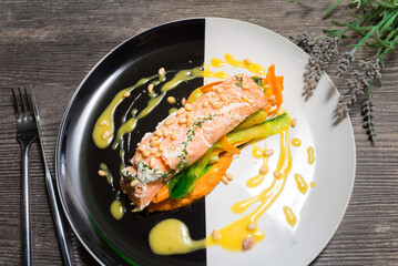 Salmon steak on a plate with Thai vegetables and sweet and sour mango sauce