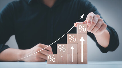 Interest rate and dividend concept, wooden block with percentage symbol and up arrow, return on...