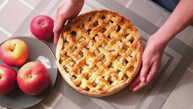 Apple pie cake preparation series - Woman's hands put freshly baked Traditional american fall dessert apple pie