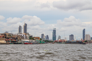 A Tug boat with a cargo ship on the Chao Phraya River in Bangkok Thailand Southeast Asia
