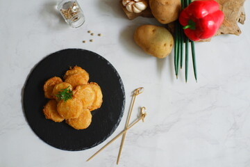 a plate of fried potato cake named perkedel kentang in Bahasa 