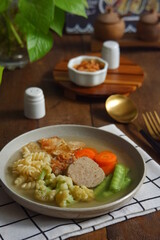 a plate of vegetables and meat soup 