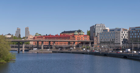 The district Norrmalm at the canal Karlbergskanalen with the transit route Klarastrandsleden and the northern railway passage to the central station a sunny day in Stockholm