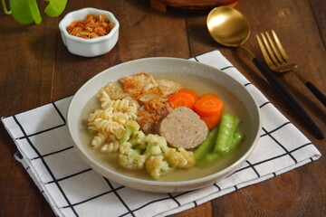 a plate of vegetables and meat soup 