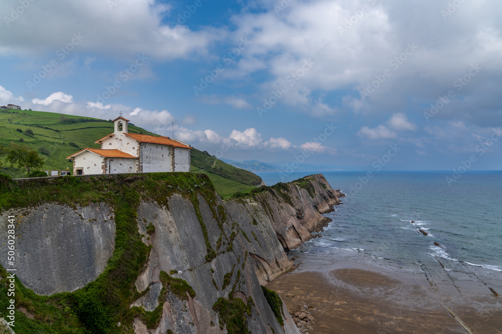 Wall mural the san telmo hermitage chapel and flysch rock formations on the basque country coast in zumaia