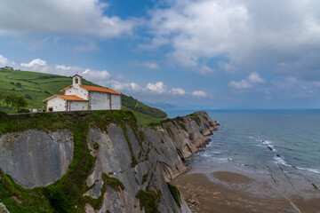 Fototapeta na wymiar the San Telmo Hermitage chapel and Flysch rock formations on the Basque Country coast in Zumaia