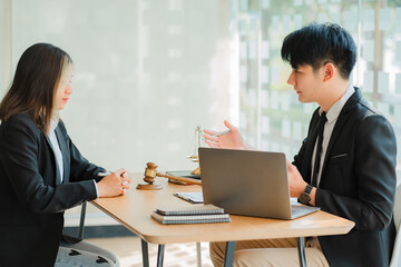 Male attorneys or judges consult team with female business clients. with hammers and scales next to the concept of legal service