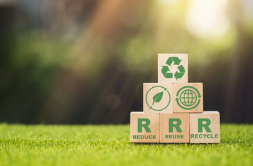 Wooden cube block over reduce, reuse and recycle text for save world on green background,...