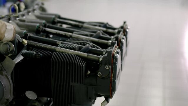 close up view of dismantled 6-piston helicopter engine in service or in air vehicle bulkhead hangar. Helicopter engine under maintenance