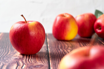 Red apple on a wooden surface.