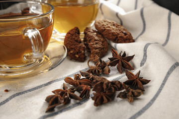 Fototapeta na wymiar Two cups of herbal tea and cookies on kitchen cloth