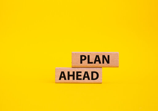 Plan ahead symbol. Wooden blocks with words 'Plan ahead'. Beautiful yellow background. Business and 'Plan ahead' concept. Copy space.