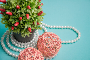 Artificial flowers white beads braided balls on a blue background. Subject photo.