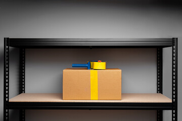 Stand shelf with one packed cardboard box