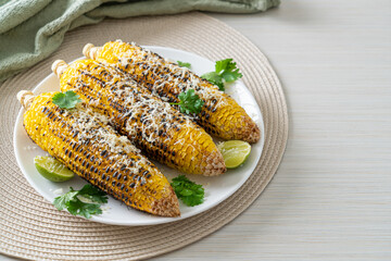barbecue and grilled corn with cheese and lime