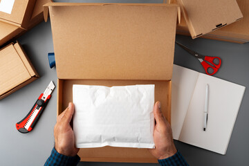 Above table top view of warehouse preparing post courier delivery package