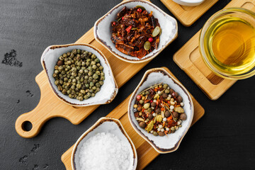 Oil, herbs and spices on wooden background