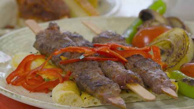 Turkish kebab serving plate.
Turkish adana kebab on a serving plate.
