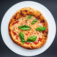 pizza on the black background, top view
