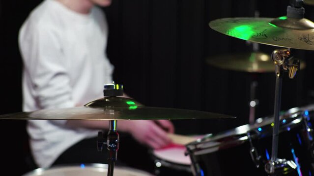 A Young Guy Novice Drummer Is Learning To Play The Drum Kit