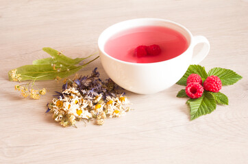 chamomile, cornflower, linden, a cup of tea with raspberries. Herbal fruit Tea Natural Strength and Healthy Eating