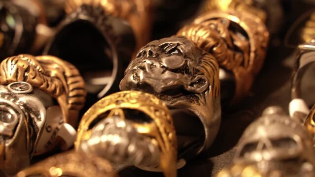 Close-up of terribly gold and silver skull rings.Skull rings that bikers or goths often wear.