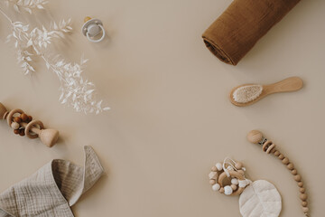 Aesthetic luxury elegant newborn baby care accessories and toys collage on neutral pastel beige background. Online fashion store, online shopping branding. Blank template with empty mockup frame