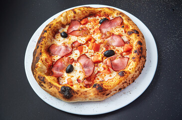 pizza on the black background, top view