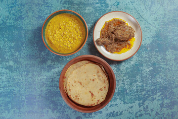 Gram pulses dal or yellow dal, chicken chap with parathas