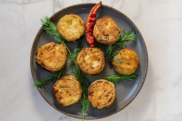 Zucchini with cheese fires with dill and red paper
