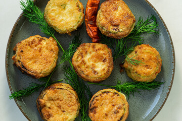 Zucchini with cheese fires with dill and red paper