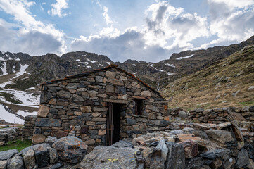 Rural cabin with the typical dry stone wall in Arcalis, Ordino in Andorra.