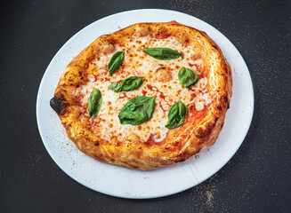 pizza on the black background, top view