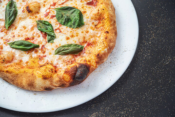 pizza on the black background, top view