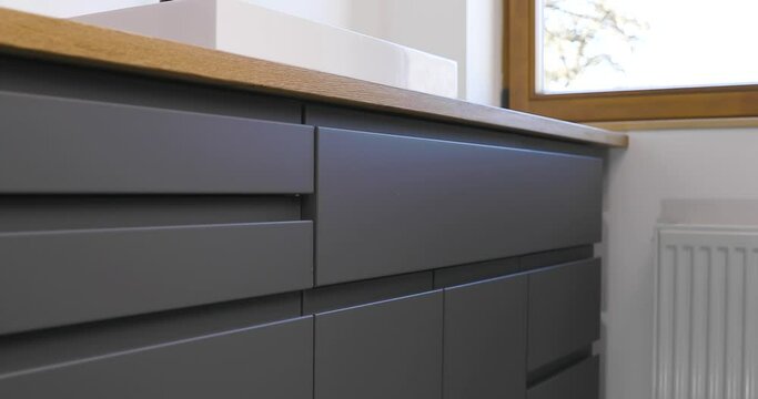 Handyman after installing chest testing. Smooth and slowly closing. Home improvement by a professional craftsperson.