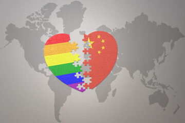 puzzle heart with the rainbow gay flag and china on a world map background. Concept.