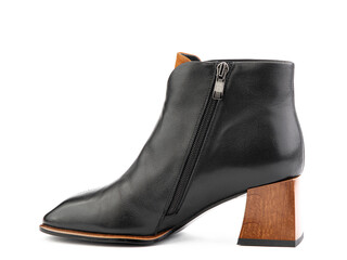 Women's autumn ankle black leather boots with black zip and average brown heels, isolated white background. Left side view. Fashion shoes.