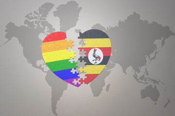 puzzle heart with the rainbow gay flag and uganda on a world map background. Concept.