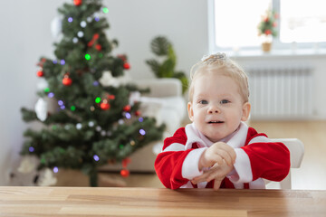 Child girl dressed in christmas dress with cochlear implants having fun at home - diversity and hearing aid and innovating technologies for treatment of deafness. Copy space and place for advertising