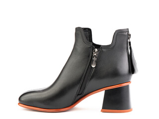 Women's autumn ankle black leather boots with zip and average heels, isolated white background. Left side view. Fashion shoes.